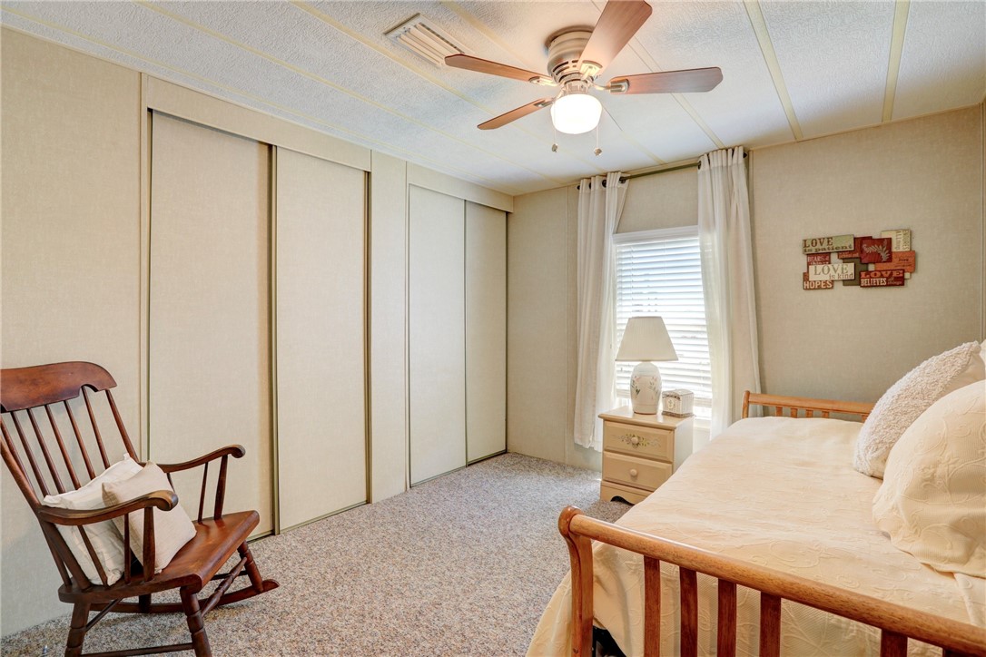 809 Oleander Circle Barefoot Bay, FL 32976 - Photo 13 of 29 a bedroom with furniture and a window
