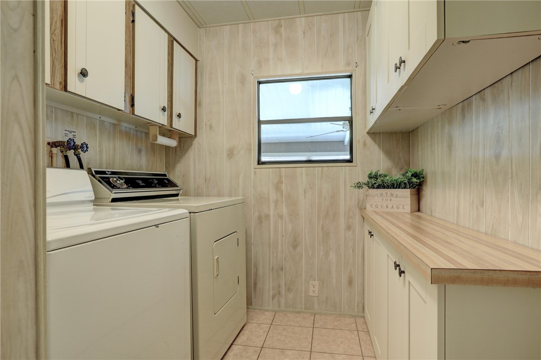 809 Oleander Circle Barefoot Bay, FL 32976 - Photo 16 of 29 a kitchen with a refrigerator and cabinets