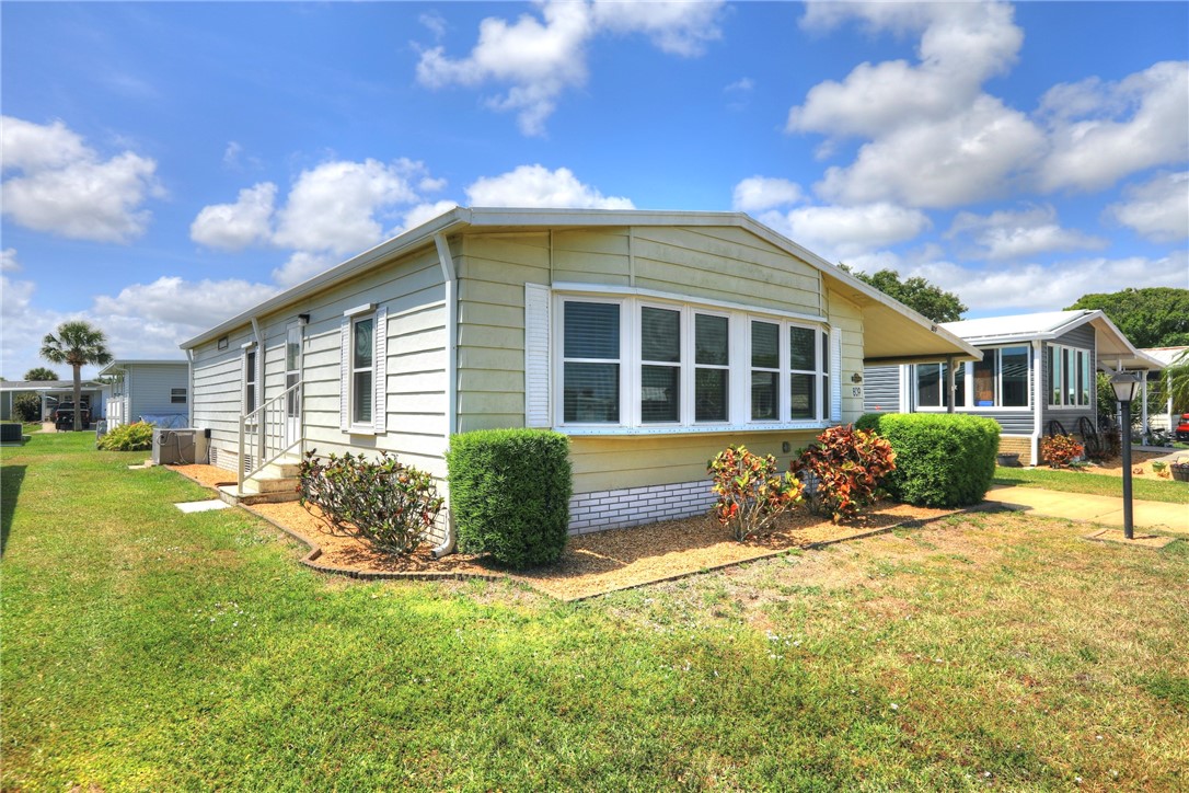 809 Oleander Circle Barefoot Bay, FL 32976 - Photo 2 of 29 a view of a house with backyard and sitting area