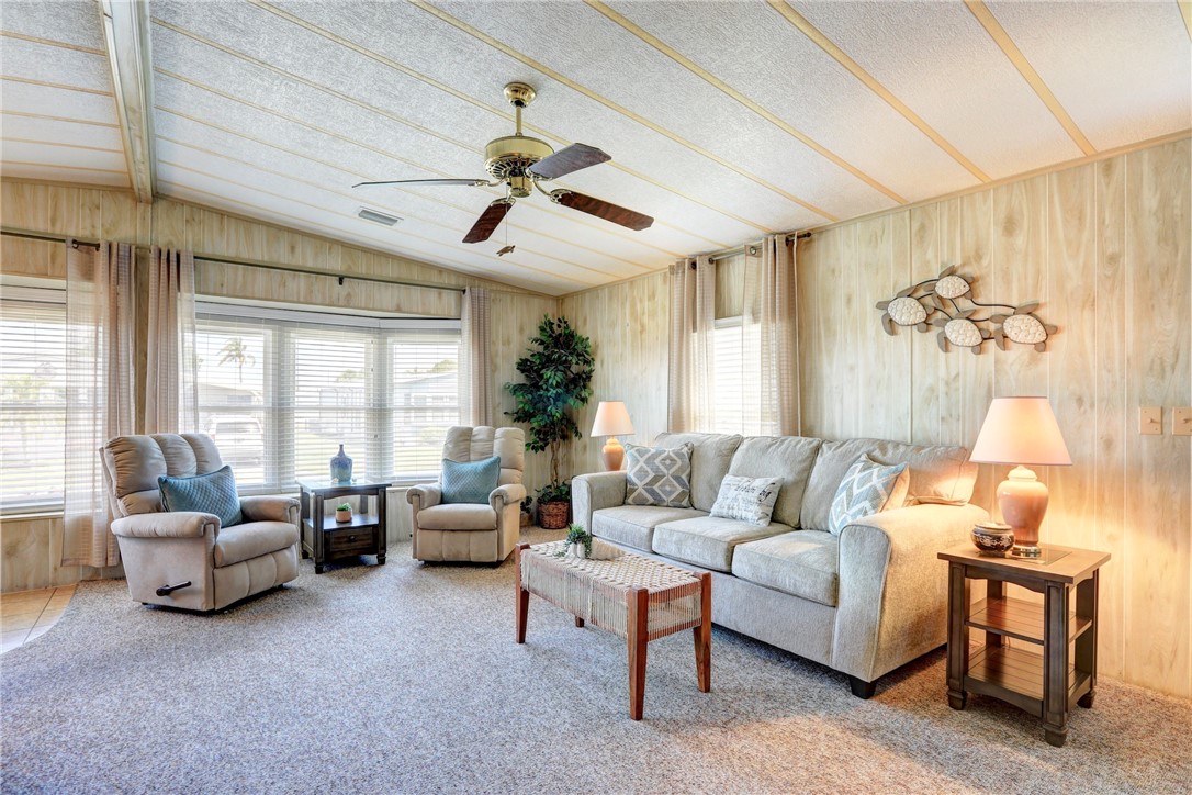 809 Oleander Circle Barefoot Bay, FL 32976 - Photo 5 of 29 a living room with furniture and a large window
