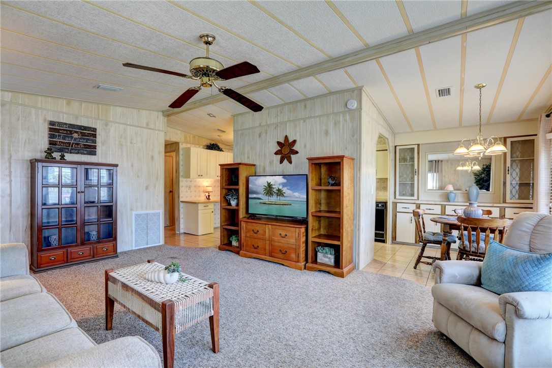 809 Oleander Circle Barefoot Bay, FL 32976 - Photo 6 of 29 a living room with furniture and a flat screen tv