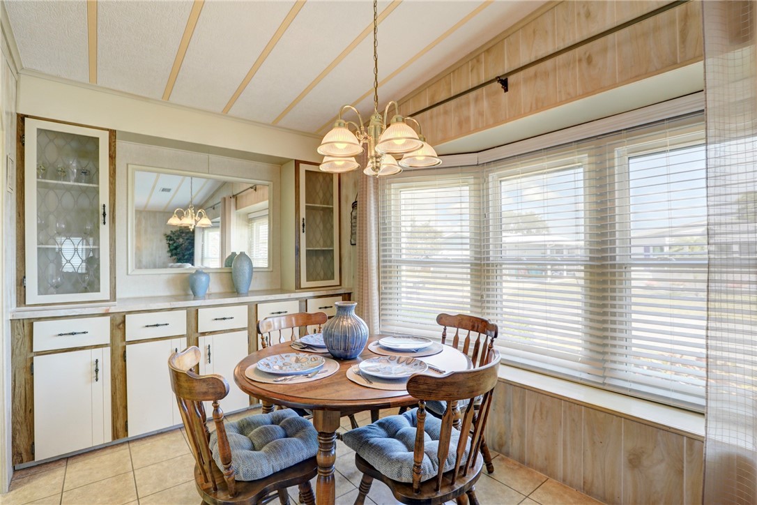 809 Oleander Circle Barefoot Bay, FL 32976 - Photo 7 of 29 a dining room with furniture and window