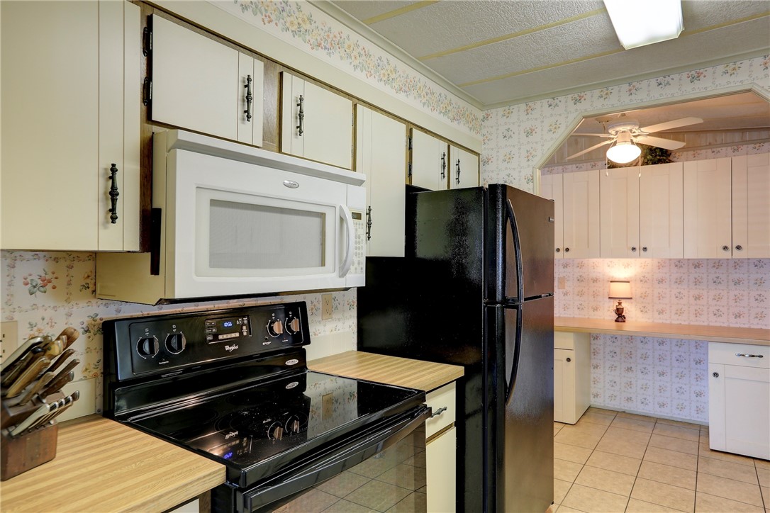 809 Oleander Circle Barefoot Bay, FL 32976 - Photo 9 of 29 a kitchen with a stove and a refrigerator