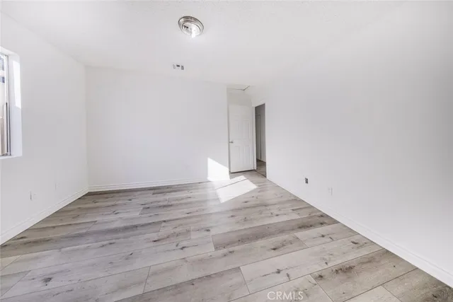 an empty room with wooden floor