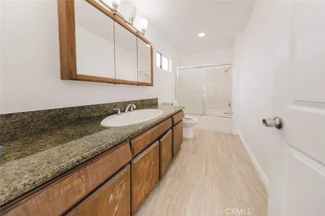 a spacious bathroom with a sink a mirror and a bathtub