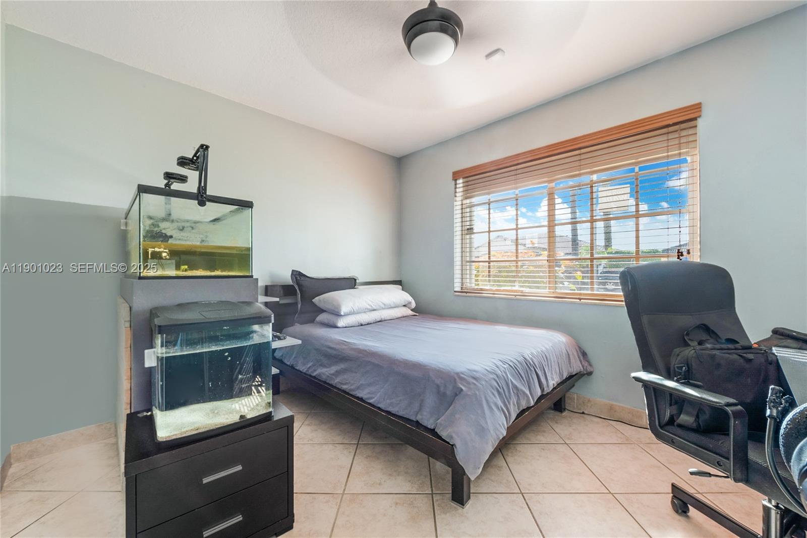 3743 Southwest 133rd Place Miami, FL 33175 - Photo 17 of 26 a bedroom with a bed and a chair