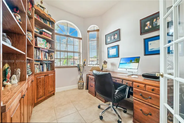 a view of a workspace with furniture and a window