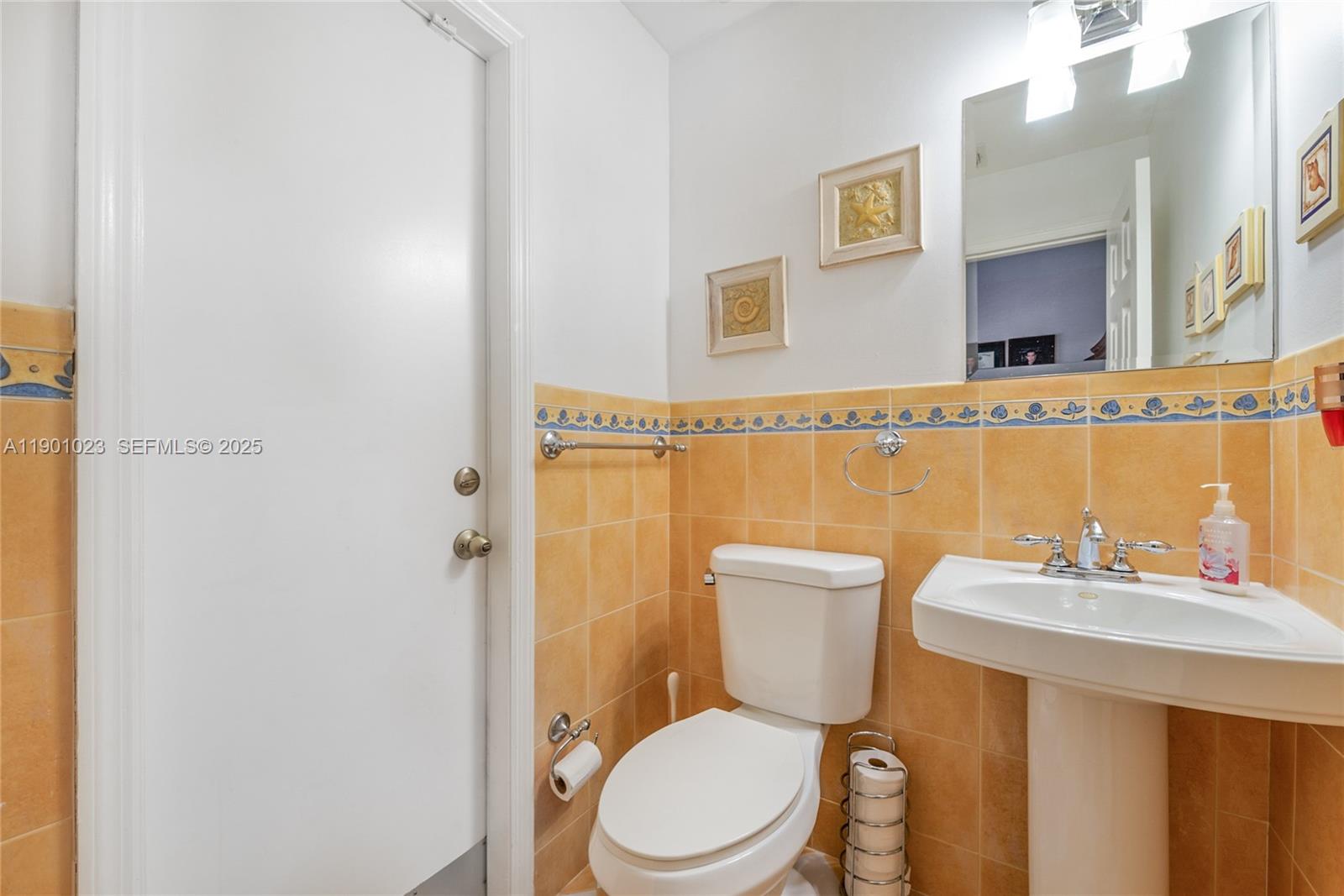 3743 Southwest 133rd Place Miami, FL 33175 - Photo 19 of 26 a bathroom with a toilet a sink and mirror