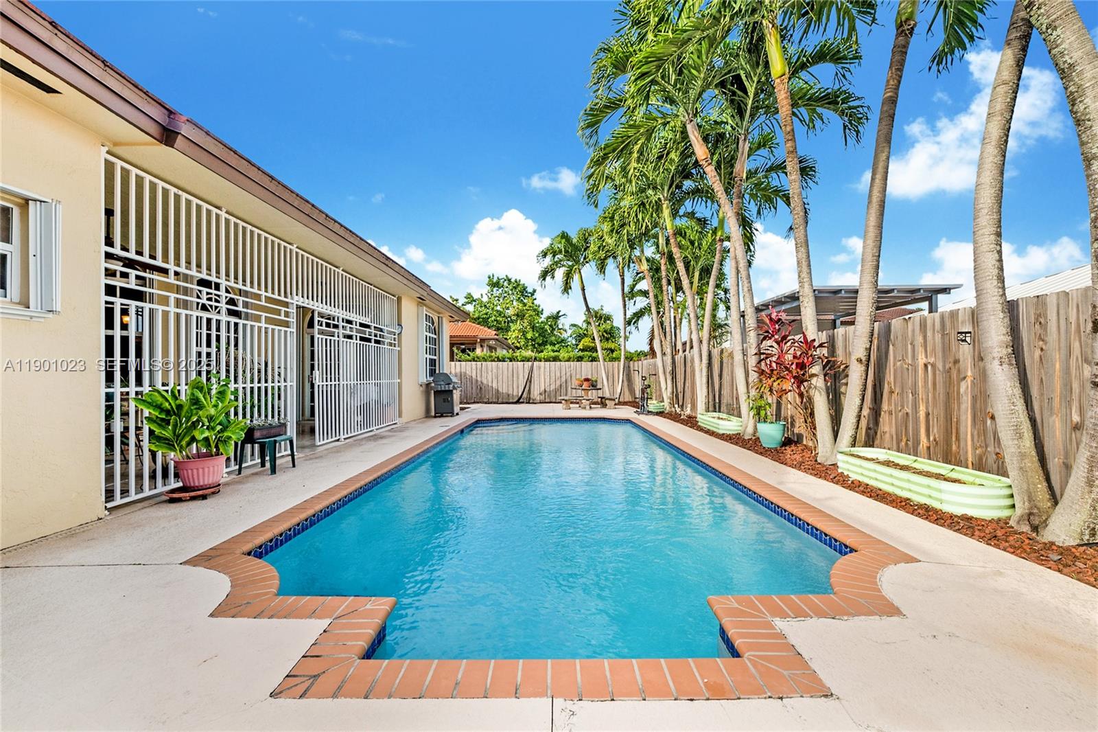 3743 Southwest 133rd Place Miami, FL 33175 - Photo 21 of 26 a view of swimming pool with outdoor seating and a patio