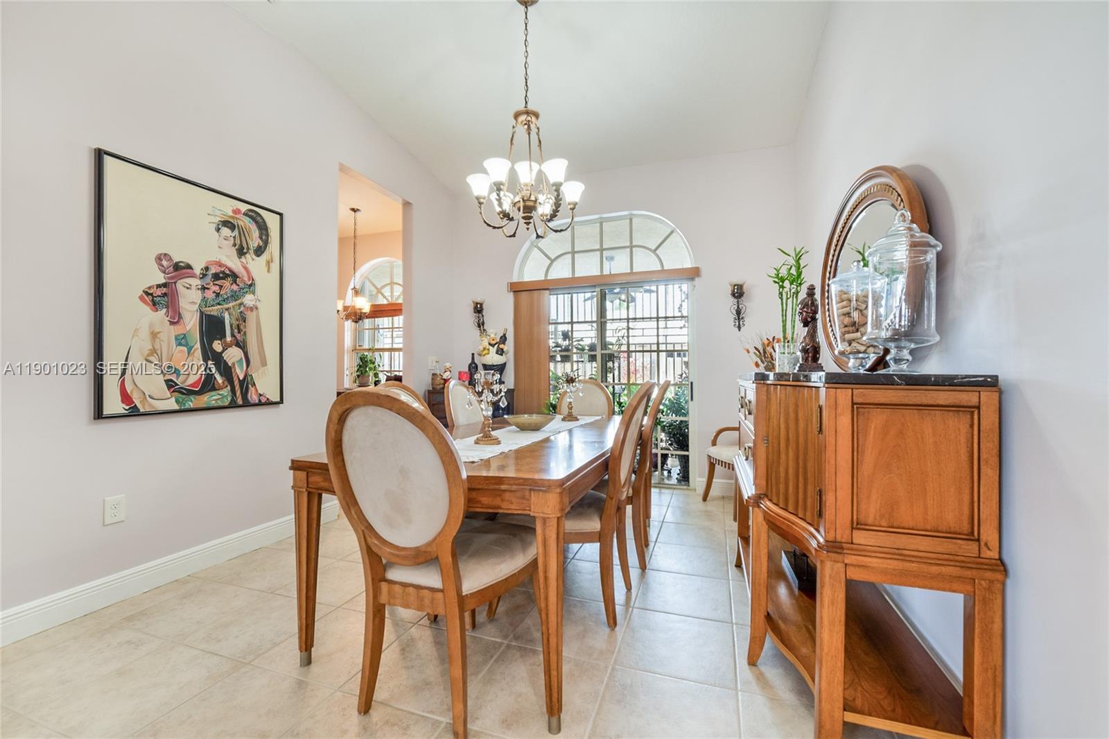 3743 Southwest 133rd Place Miami, FL 33175 - Photo 7 of 26 a view of a dining room with furniture a chandelier and wooden floor