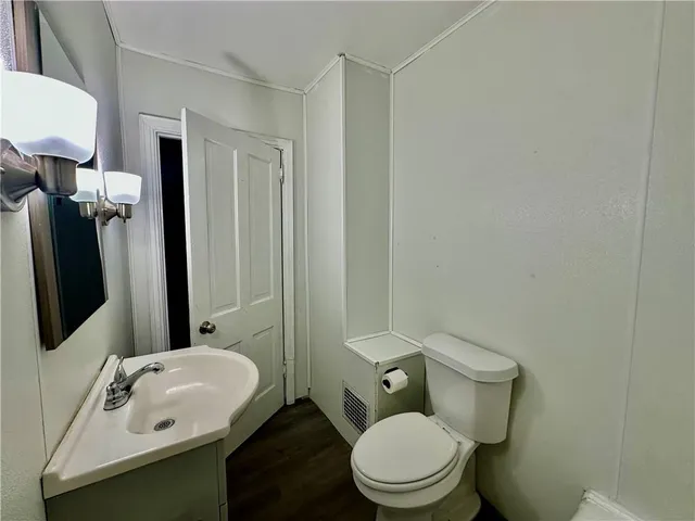 a view of a room with wooden floor and bathroom