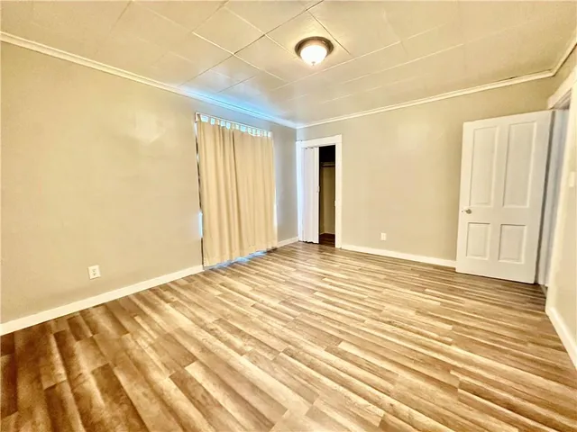 a view of a livingroom with wooden floor and a window