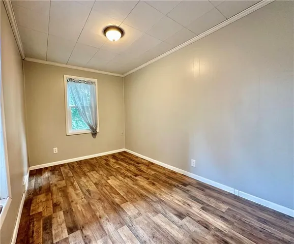 a view of a yard with large trees and a barn in it