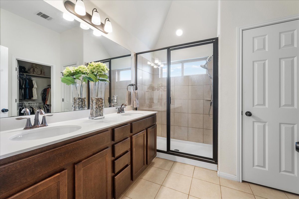 3000 Rio Verde Drive Leander, TX 78641 - Photo 12 of 23 a bathroom with a double vanity sink and a mirror