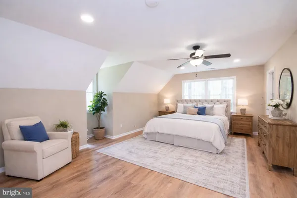 a spacious bedroom with a large bed and a chandelier