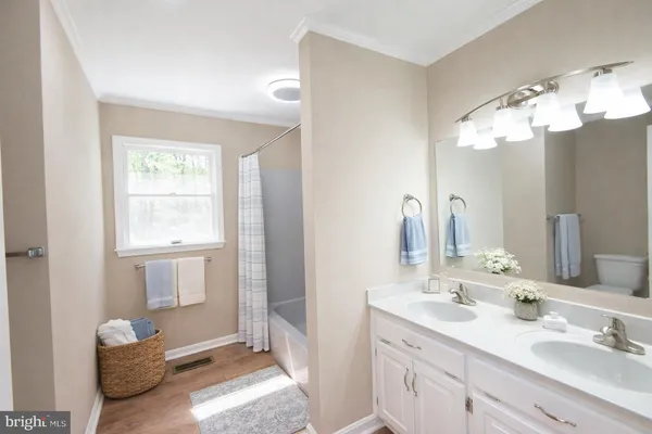 a bathroom with a sink double vanity and a mirror