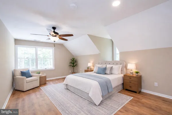 a bedroom with a bed and a couch