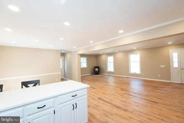 a view of a room with wooden floor and window