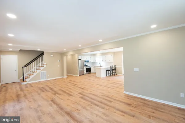 a view of an empty room with wooden floor