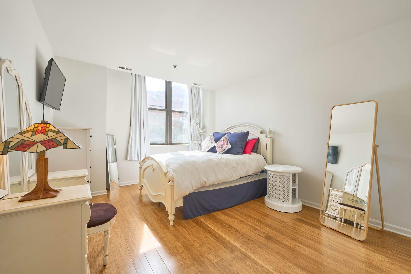 780 South Federal Street, Unit 310 Chicago, IL 60605 - Photo 13 of 18 a bedroom with a bed and wooden floor