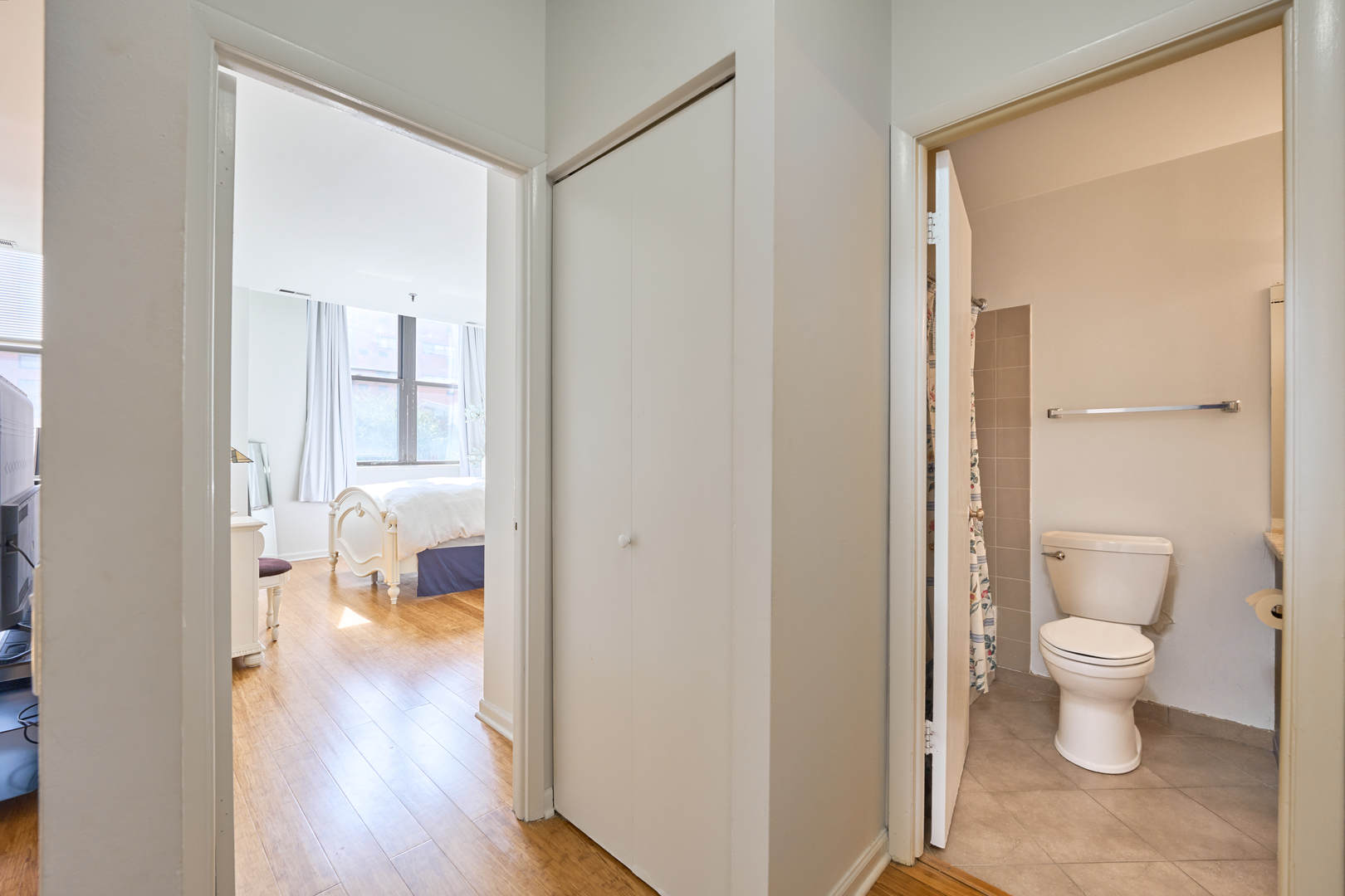 780 South Federal Street, Unit 310 Chicago, IL 60605 - Photo 10 of 18 a bathroom view of a toilet and a glass door