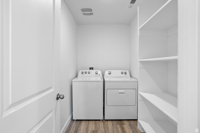2194 Wolverine Way, Unit 2531 Washington, UT 84780 - Photo 22 of 52 Dedicated laundry area featuring a washer and dryer, wood-finish flooring, recessed lighting, and built-in shelving