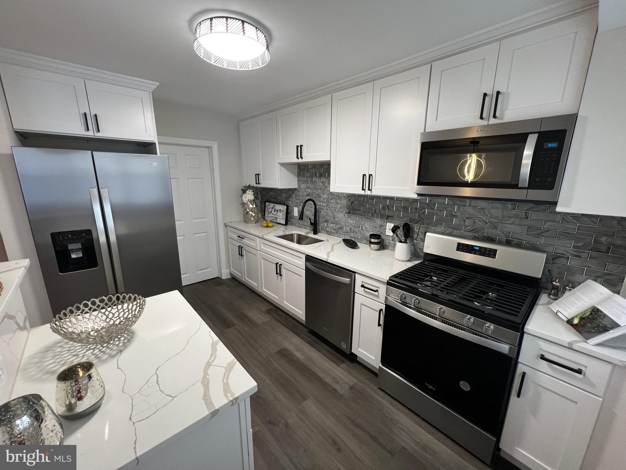 1655 Winford Road Baltimore, MD 21239 - Photo 1 of 44 a kitchen with a sink stove and refrigerator