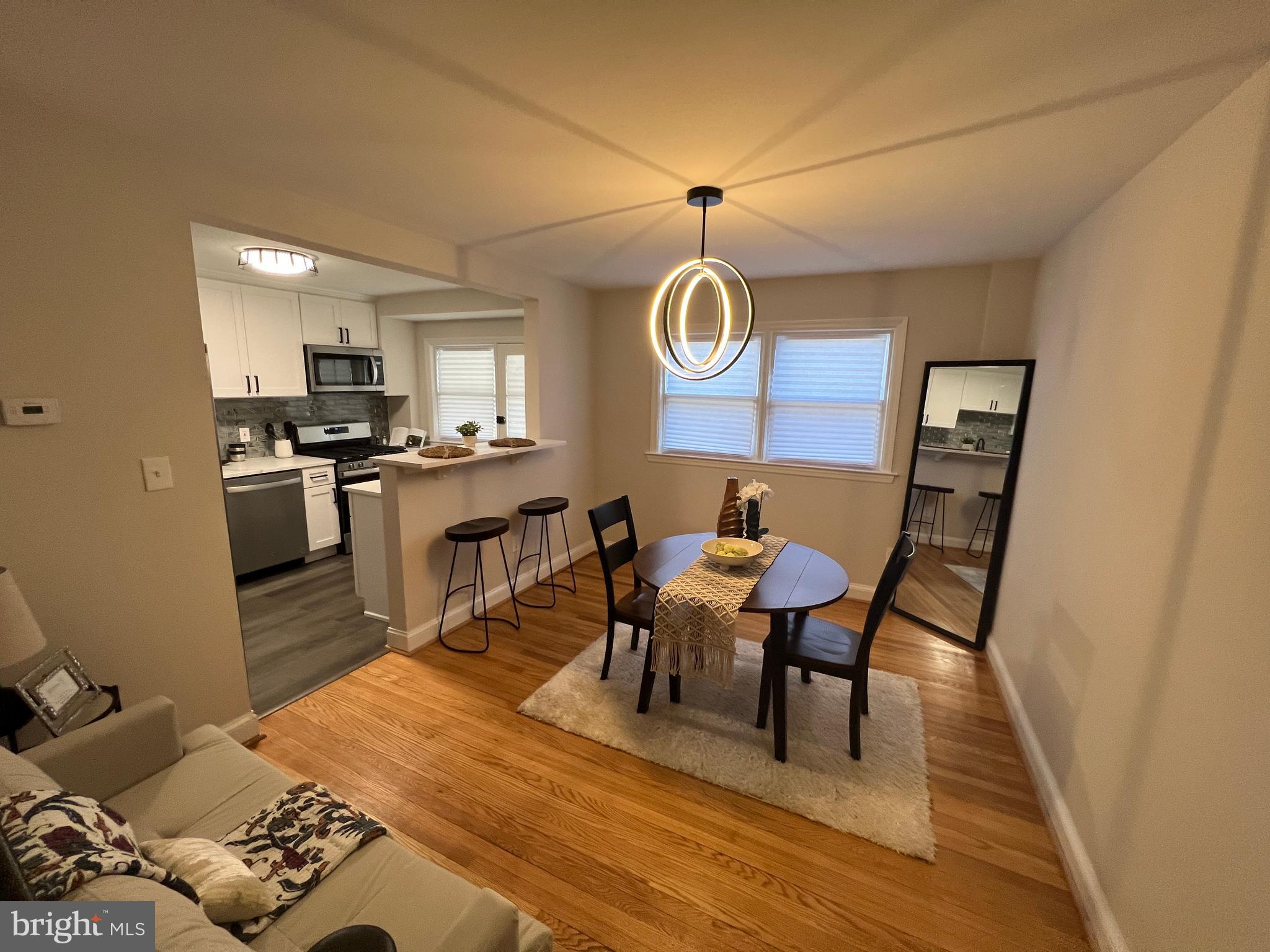 1655 Winford Road Baltimore, MD 21239 - Photo 7 of 44 a view of a dining room with furniture and wooden floor