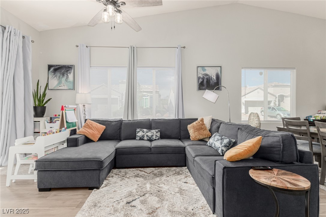 6125 Powdermill Street Las Vegas, NV 89148 - Photo 12 of 33 Living area featuring light wood-style floors, lofted ceiling, and ceiling fan