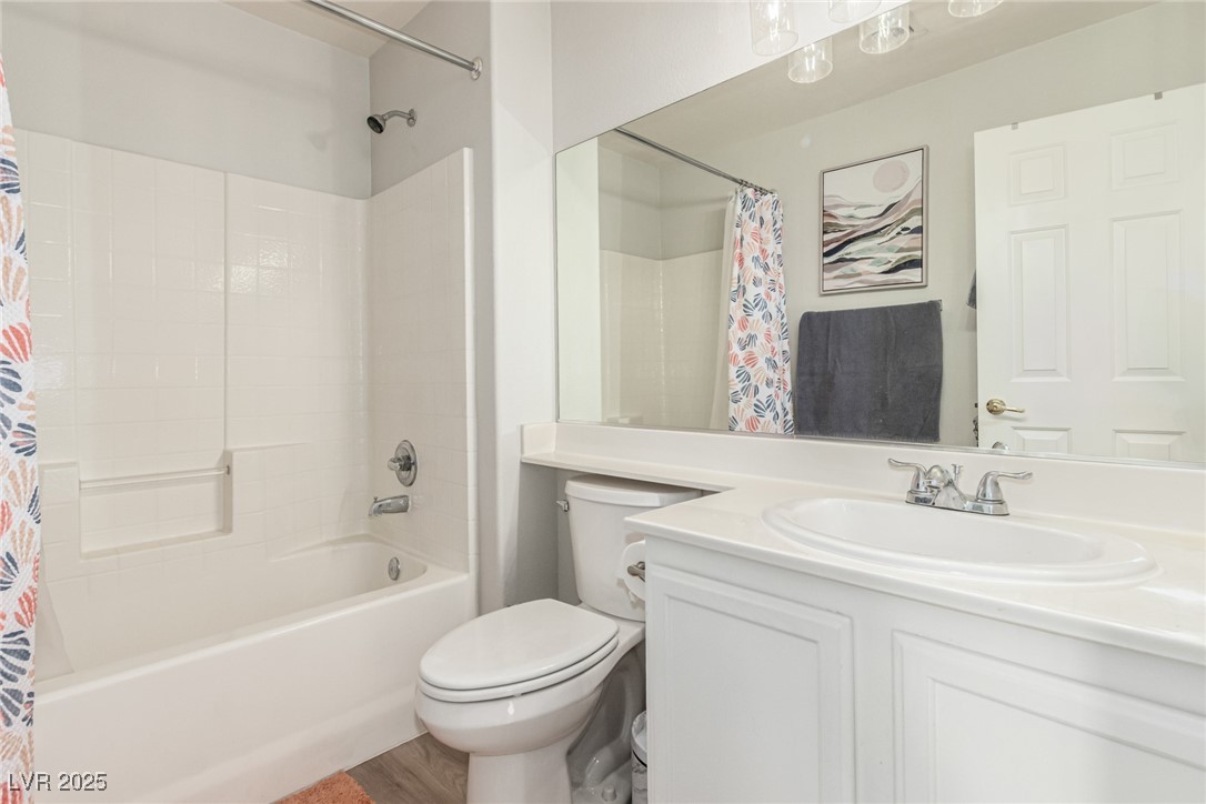 6125 Powdermill Street Las Vegas, NV 89148 - Photo 13 of 33 Full bath with vanity, shower / bath combination with curtain, and wood finished floors