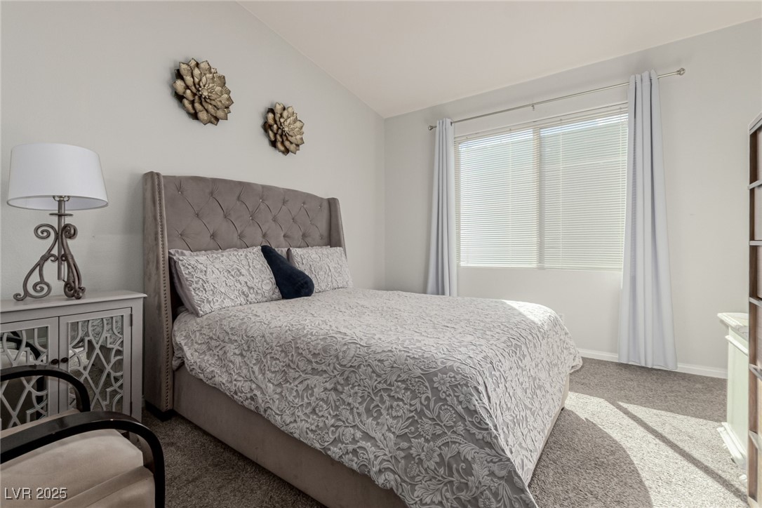 6125 Powdermill Street Las Vegas, NV 89148 - Photo 16 of 33 Carpeted bedroom featuring baseboards and vaulted ceiling