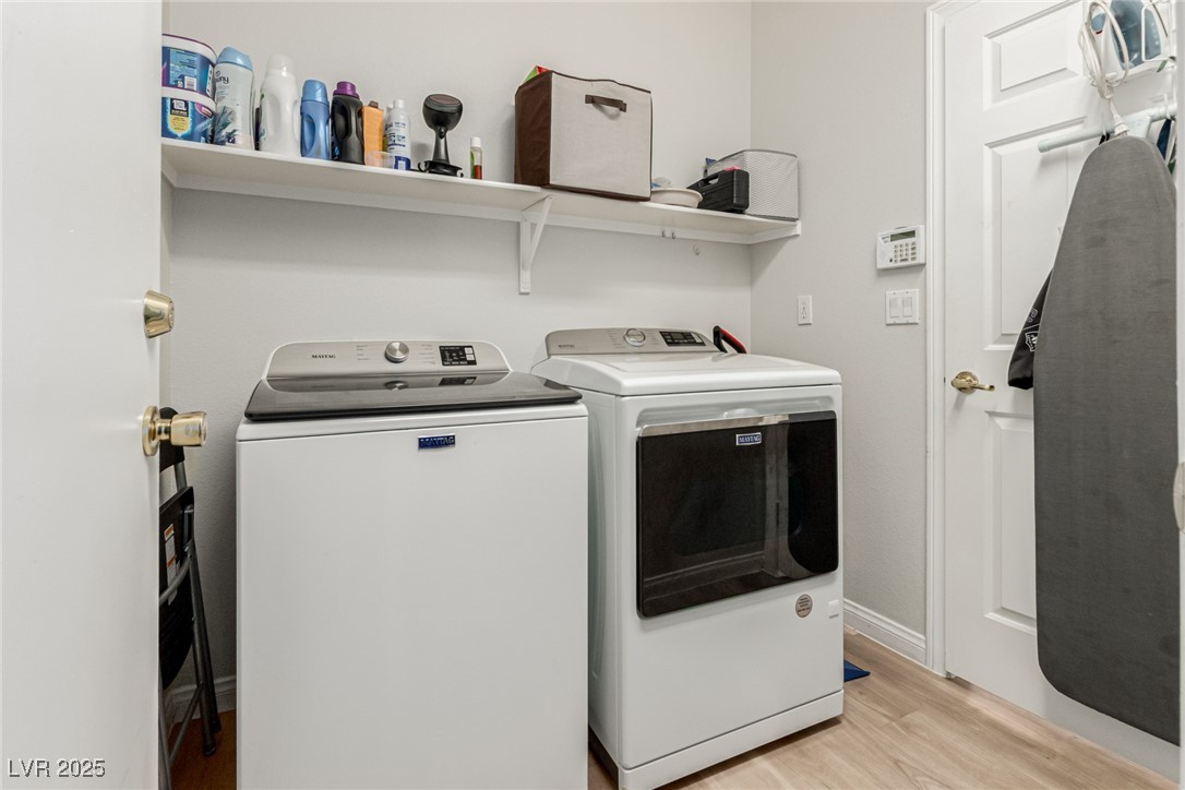6125 Powdermill Street Las Vegas, NV 89148 - Photo 22 of 33 Laundry room featuring light wood-style floors and washing machine and clothes dryer