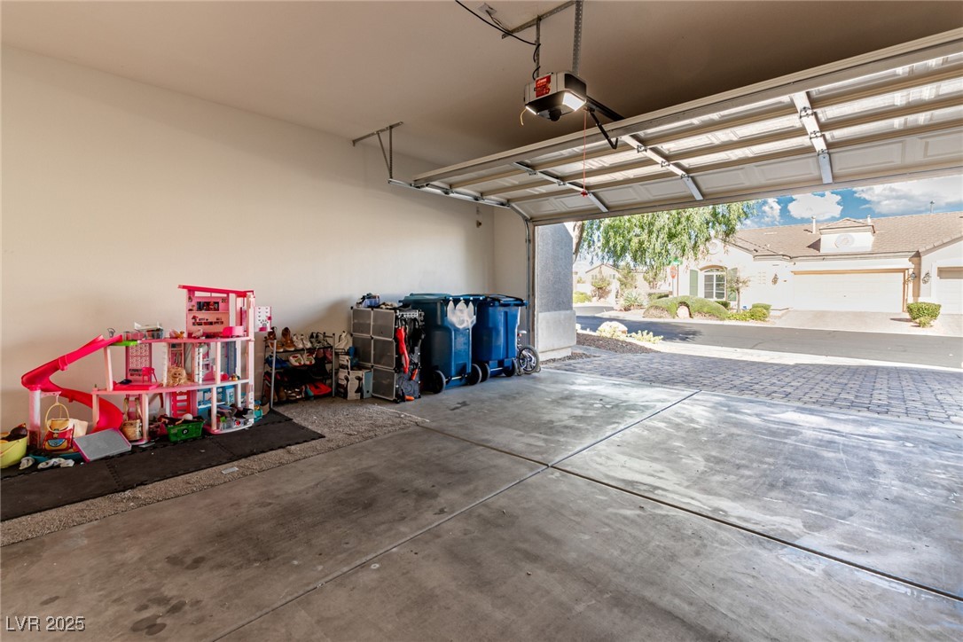 6125 Powdermill Street Las Vegas, NV 89148 - Photo 23 of 33 Garage featuring a garage door opener