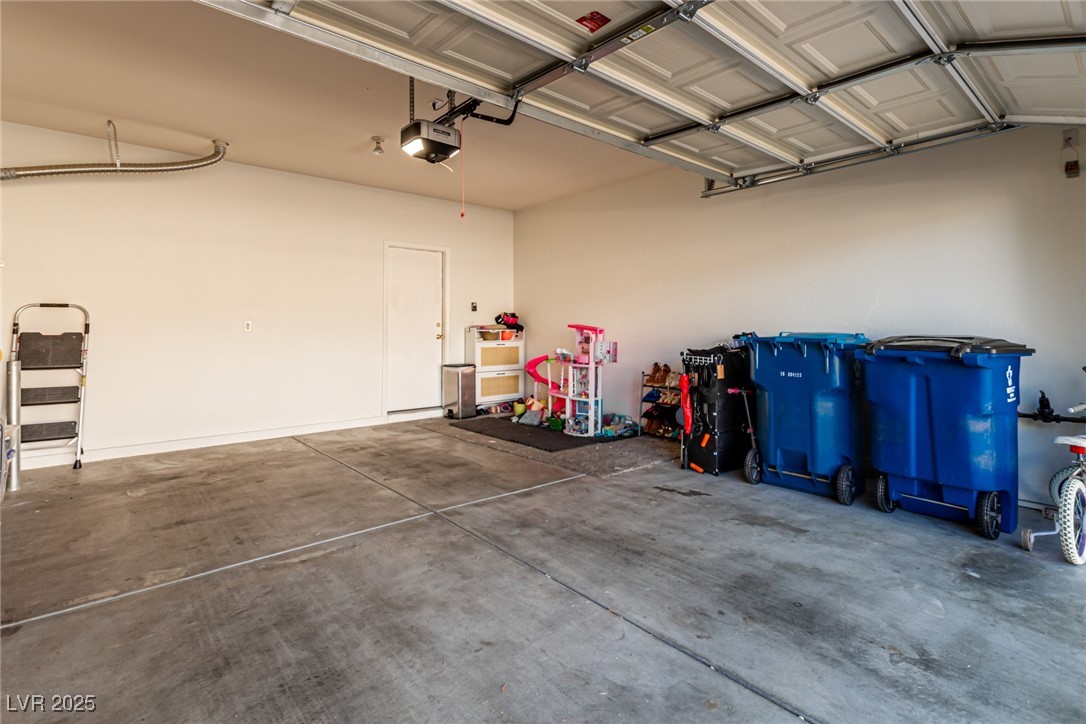 6125 Powdermill Street Las Vegas, NV 89148 - Photo 24 of 33 Garage featuring a garage door opener