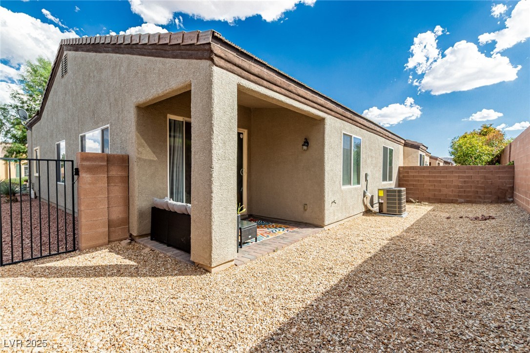6125 Powdermill Street Las Vegas, NV 89148 - Photo 27 of 33 Rear view of house featuring a fenced backyard, a patio area, stucco siding, and a gate