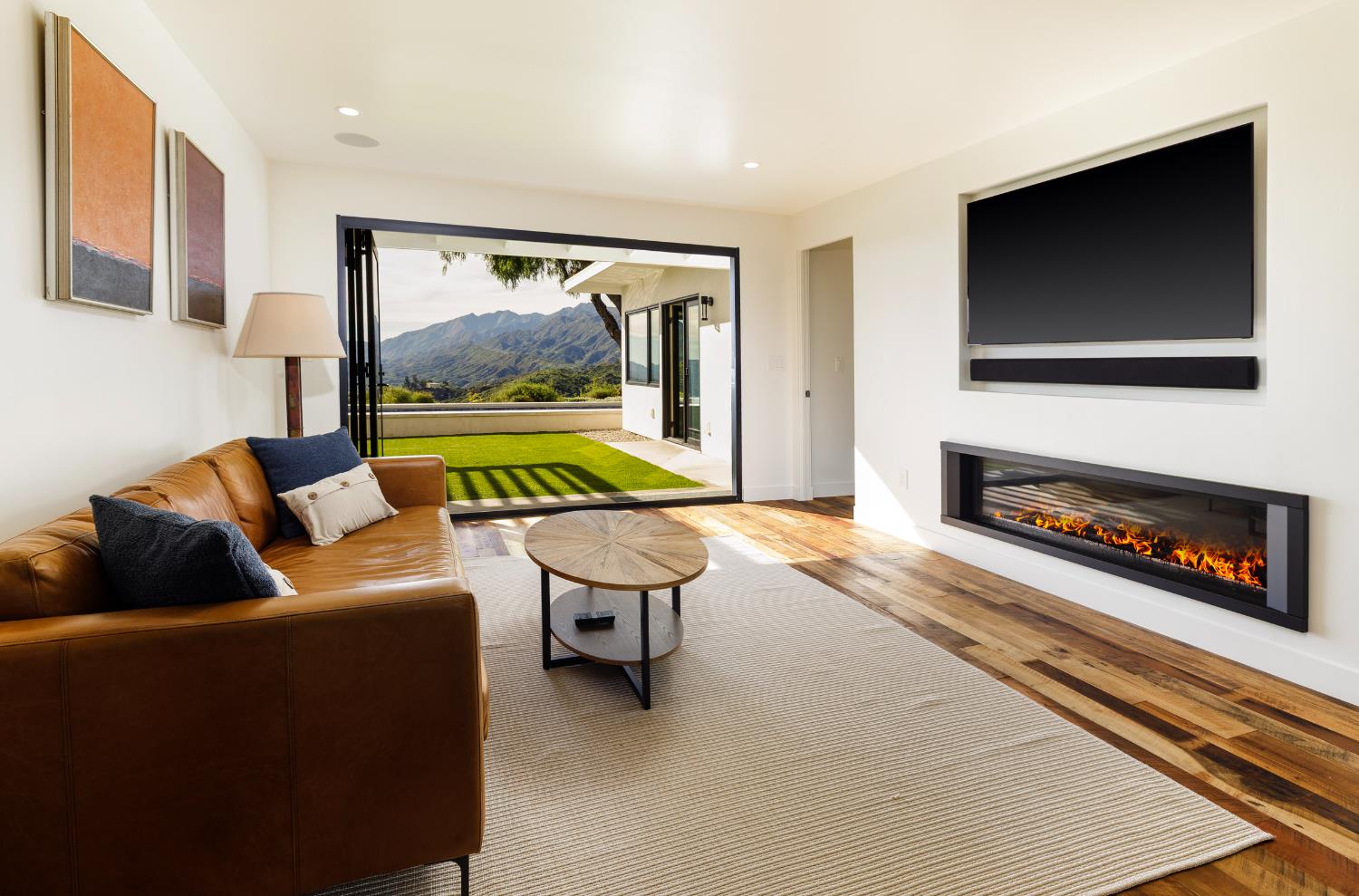 1417 Foothill Road Ojai, CA 93023 - Photo 14 of 41 a living room with furniture a flat screen tv and a fireplace