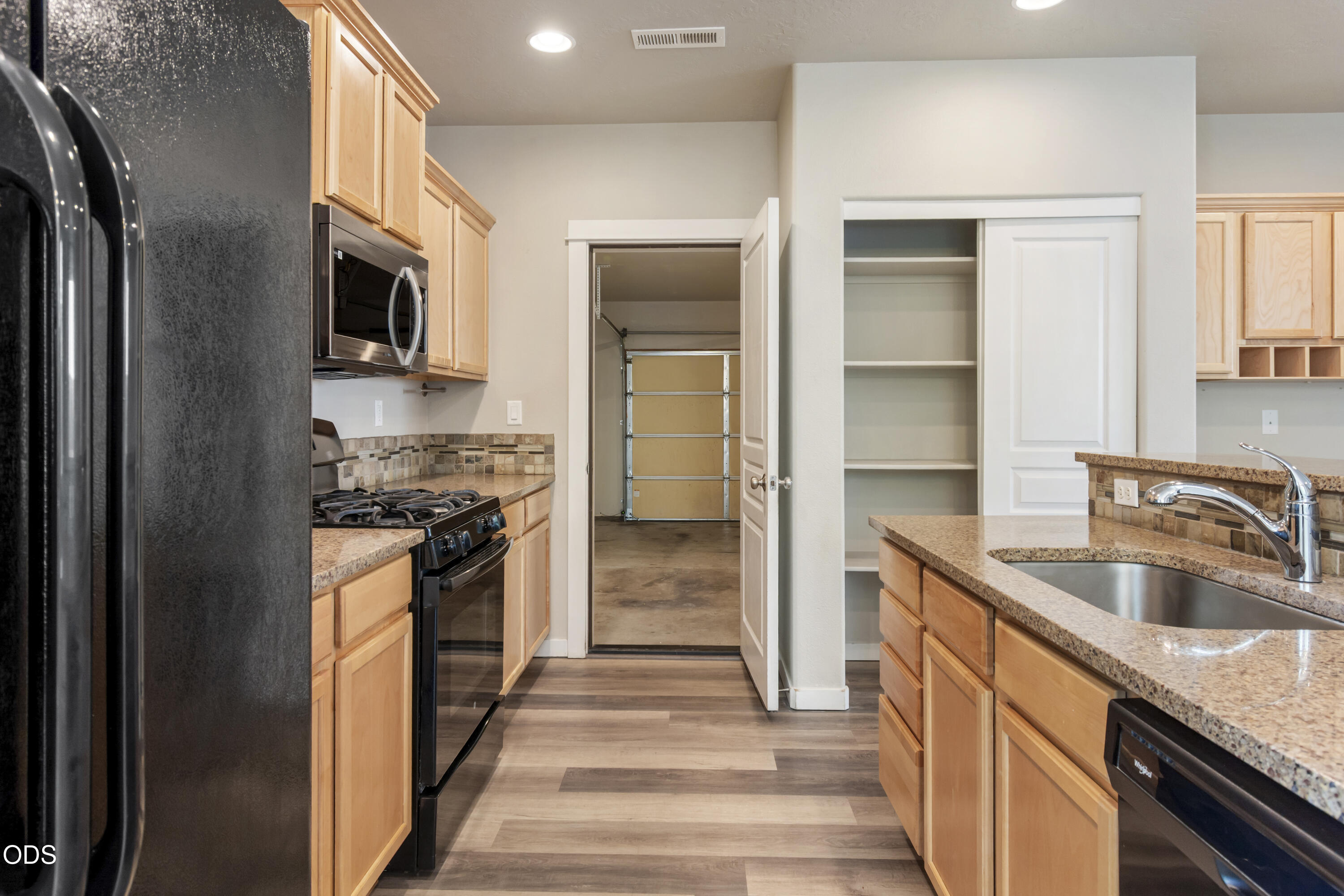 21332 Oconnor Way Bend, OR 97701 - Photo 15 of 33 a kitchen with stainless steel appliances granite countertop a refrigerator and a sink