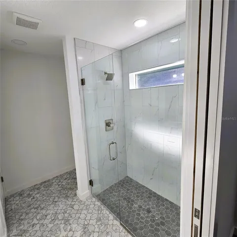 a view of a bathroom with a glass door shower