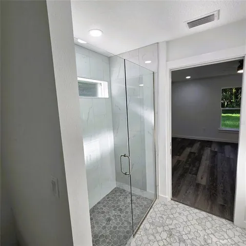 a bathroom with a shower and a mirror