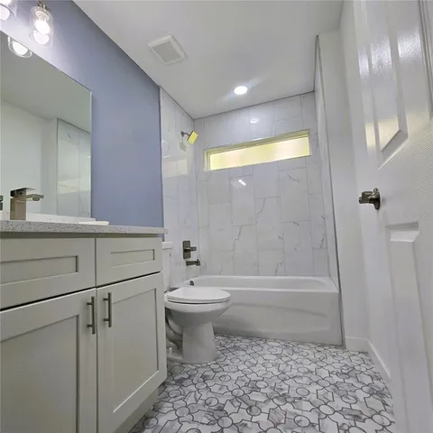 a bathroom with a toilet a sink and bathtub