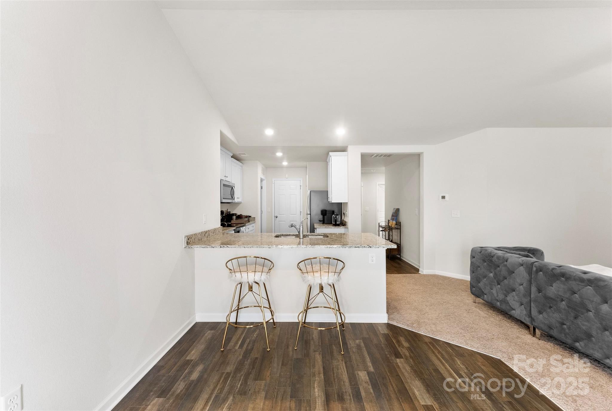223 Frank Burns Way Kings Mountain, NC 28086 - Photo 14 of 36 a living room with a couch and a dining table with wooden floor