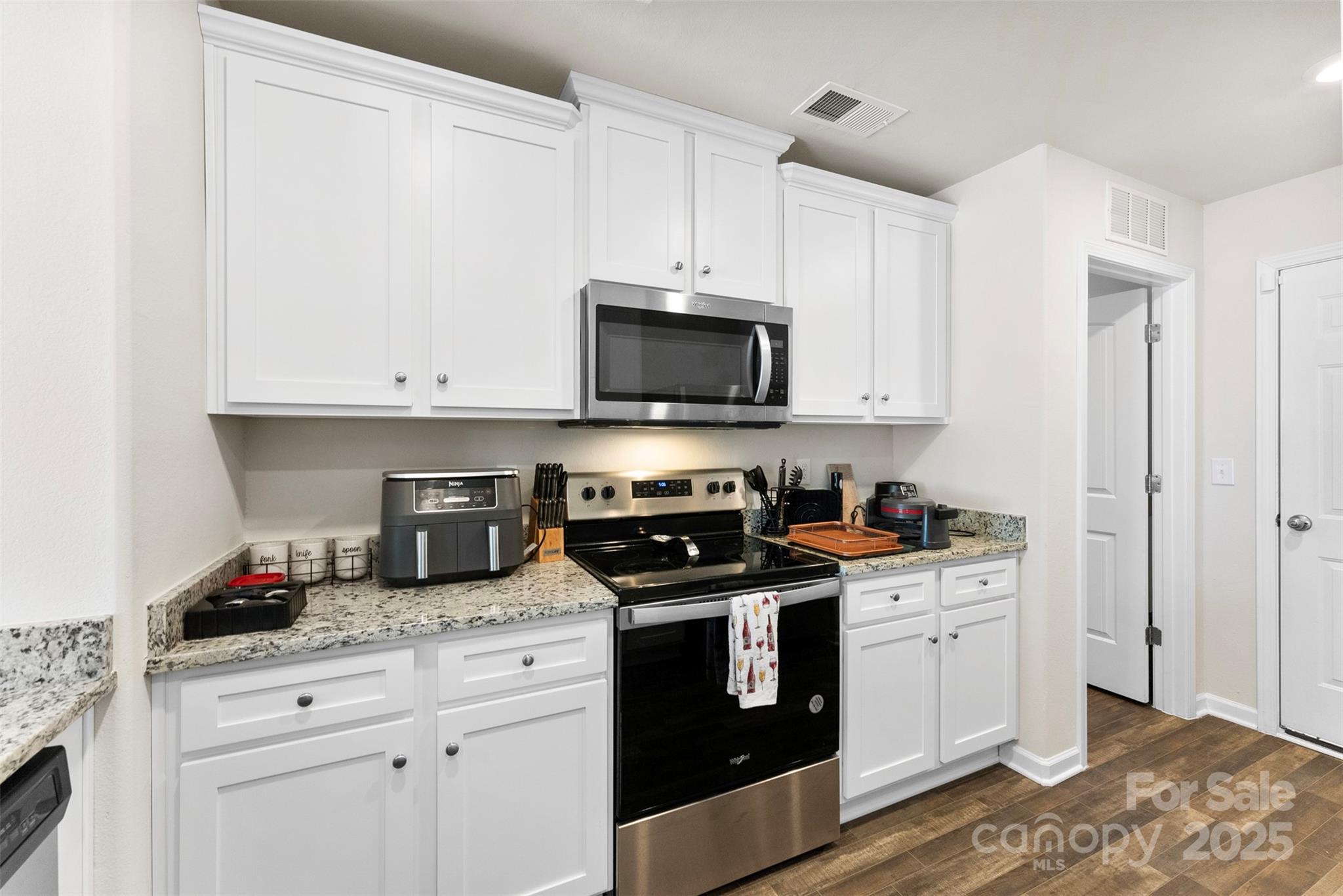 223 Frank Burns Way Kings Mountain, NC 28086 - Photo 18 of 36 a kitchen with stainless steel appliances granite countertop a stove a sink and a microwave