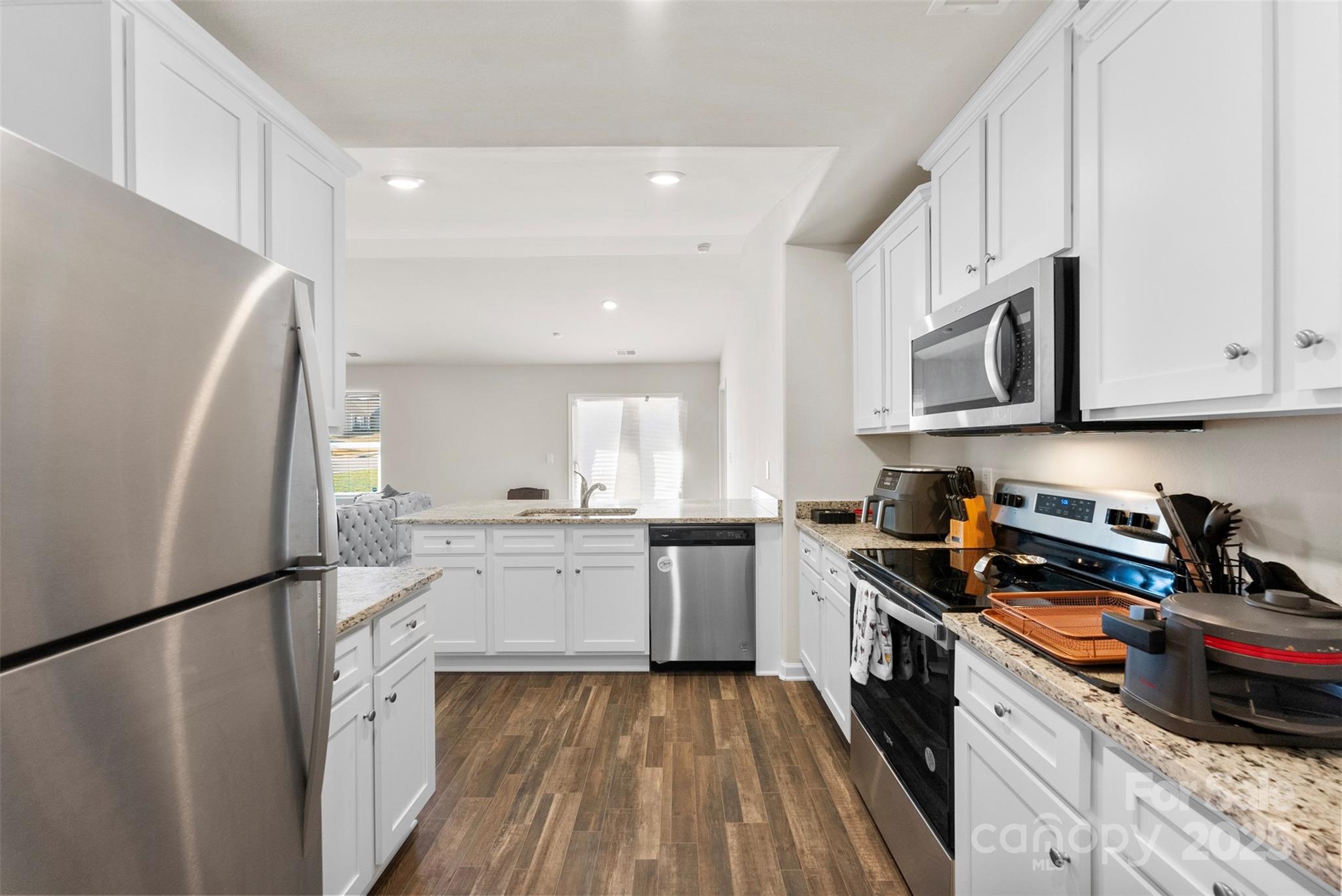 223 Frank Burns Way Kings Mountain, NC 28086 - Photo 19 of 36 a kitchen with a refrigerator a stove a microwave and cabinets
