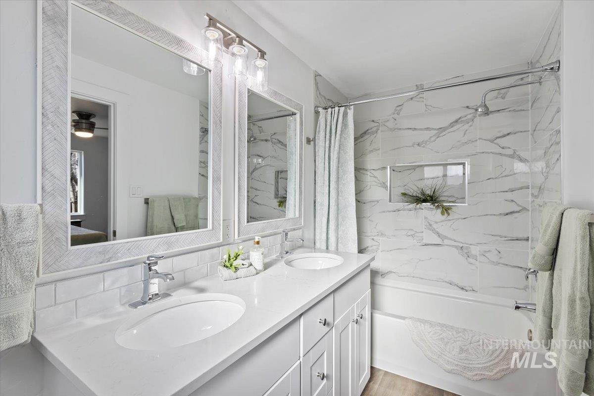 1184 Starfire Street Twin Falls, ID 83301 - Photo 17 of 34 Bathroom with a combined bath / shower with marble appearance, double vanity, and decorative backsplash