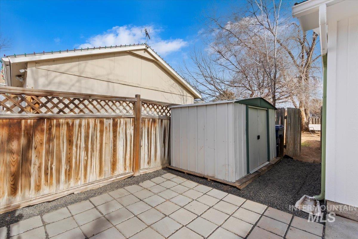 1184 Starfire Street Twin Falls, ID 83301 - Photo 33 of 34 Fenced backyard with a storage unit and a patio