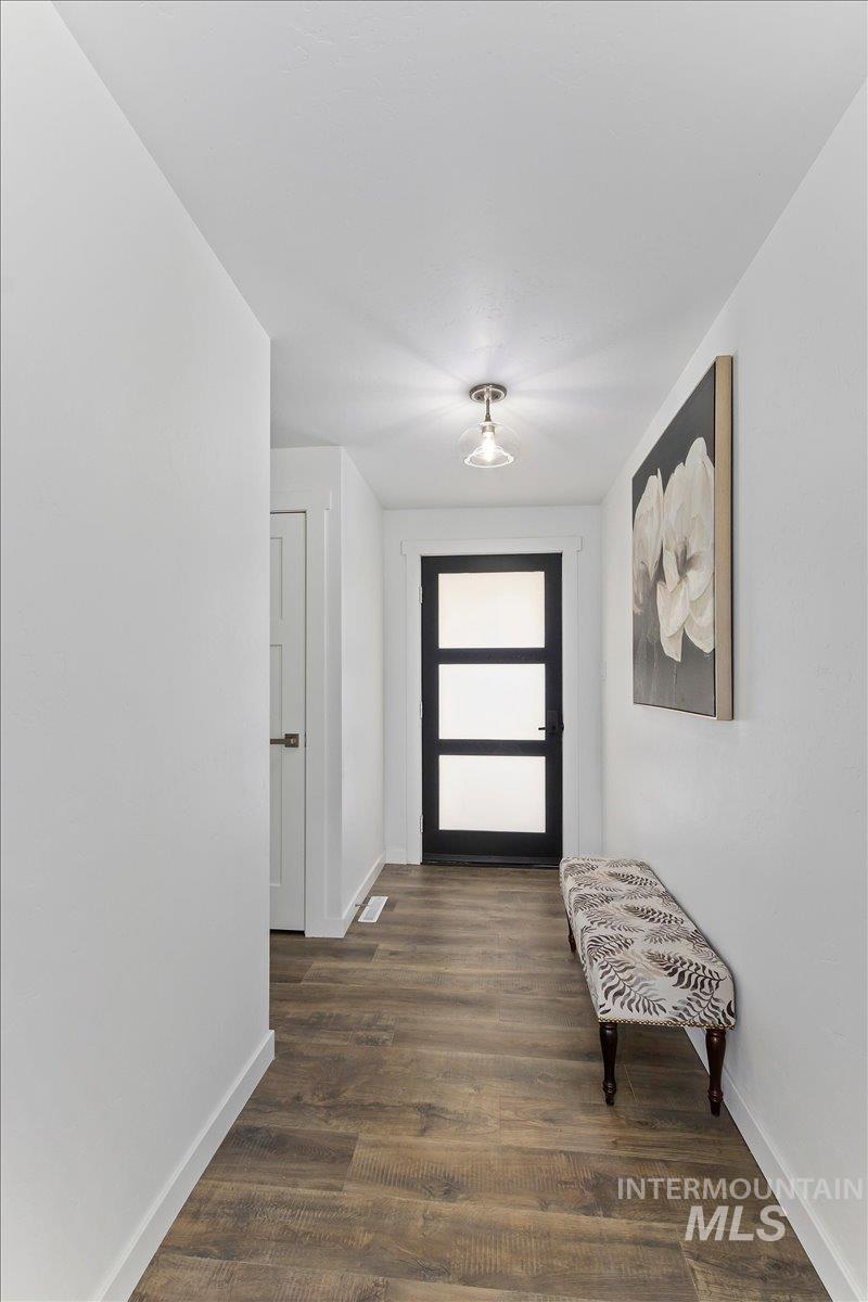 1184 Starfire Street Twin Falls, ID 83301 - Photo 6 of 34 Foyer entrance with dark wood-style flooring and baseboards