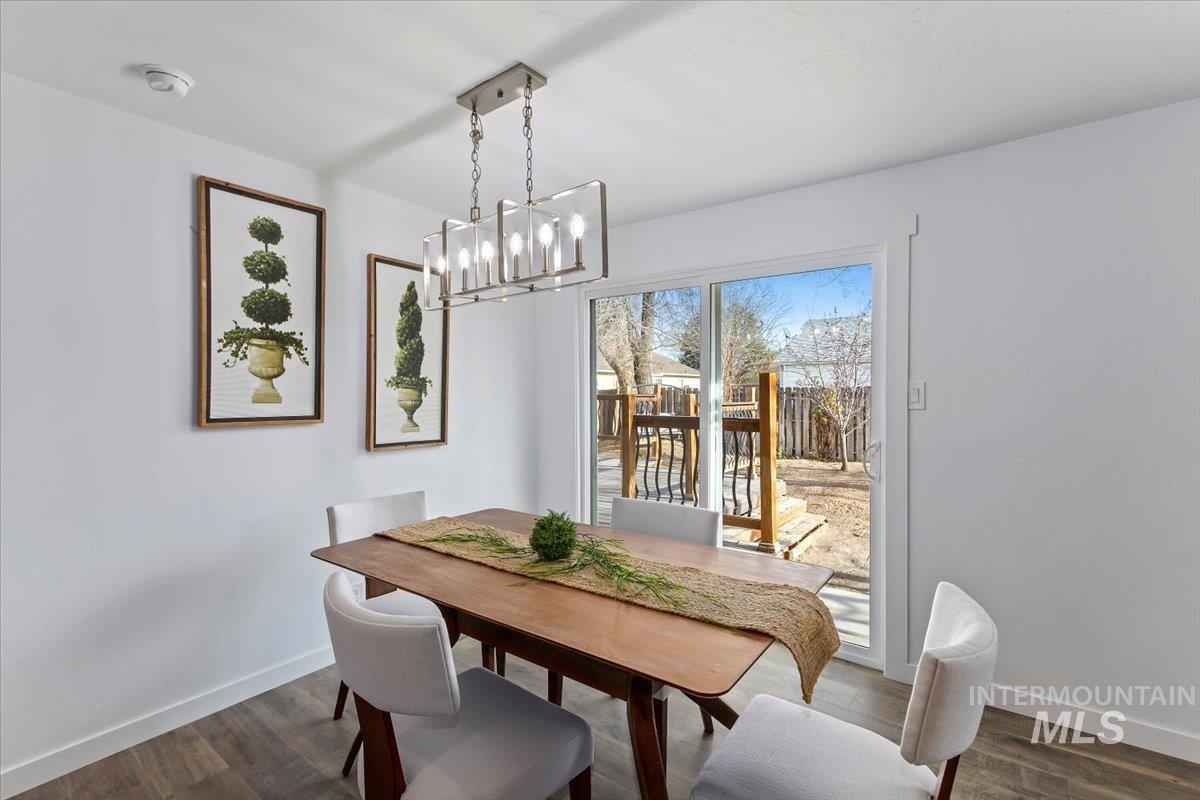 1184 Starfire Street Twin Falls, ID 83301 - Photo 10 of 34 Dining room with dark wood-style flooring and a chandelier