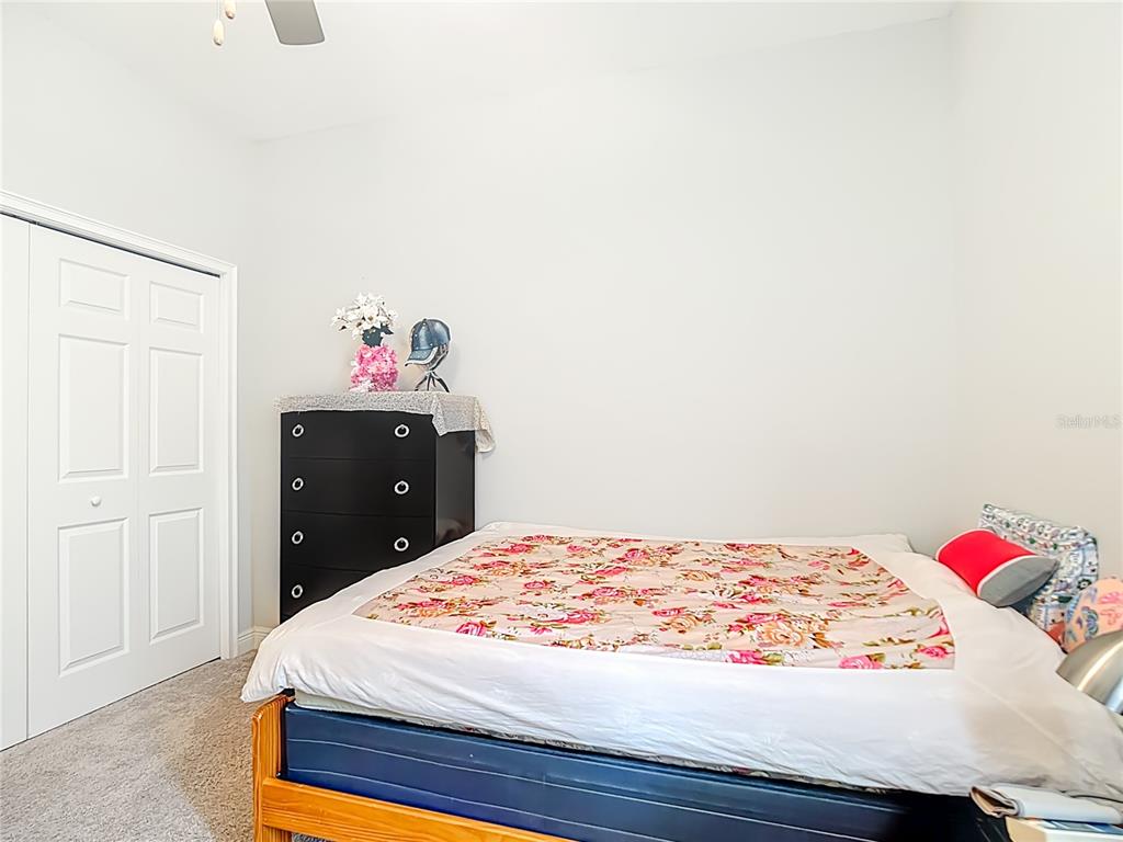 237 Walkers Point Drive Auburndale, FL 33823 - Photo 16 of 31 a bedroom with a bed and a dresser