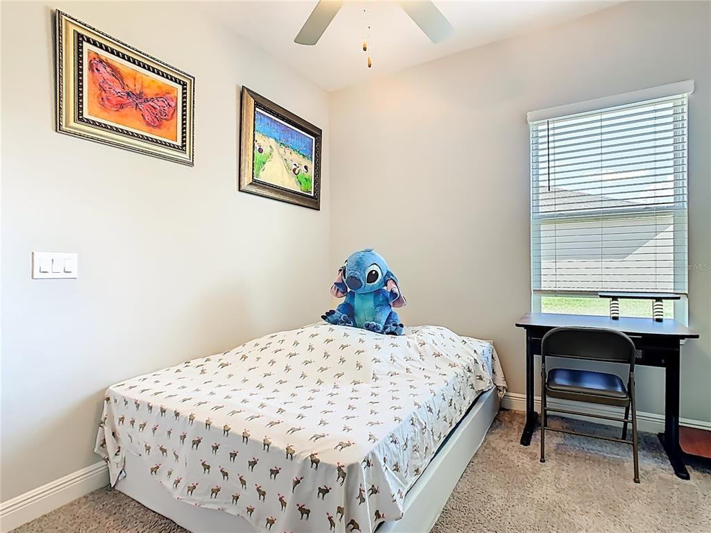 237 Walkers Point Drive Auburndale, FL 33823 - Photo 18 of 31 a bedroom with a bed and a table