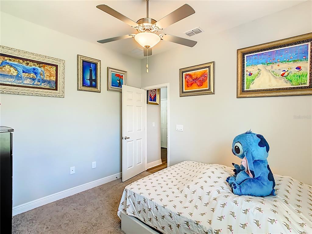 237 Walkers Point Drive Auburndale, FL 33823 - Photo 19 of 31 a bedroom with a bed and cabinets